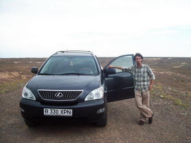 Nenad posing with his driver's car in Kazakhstan.